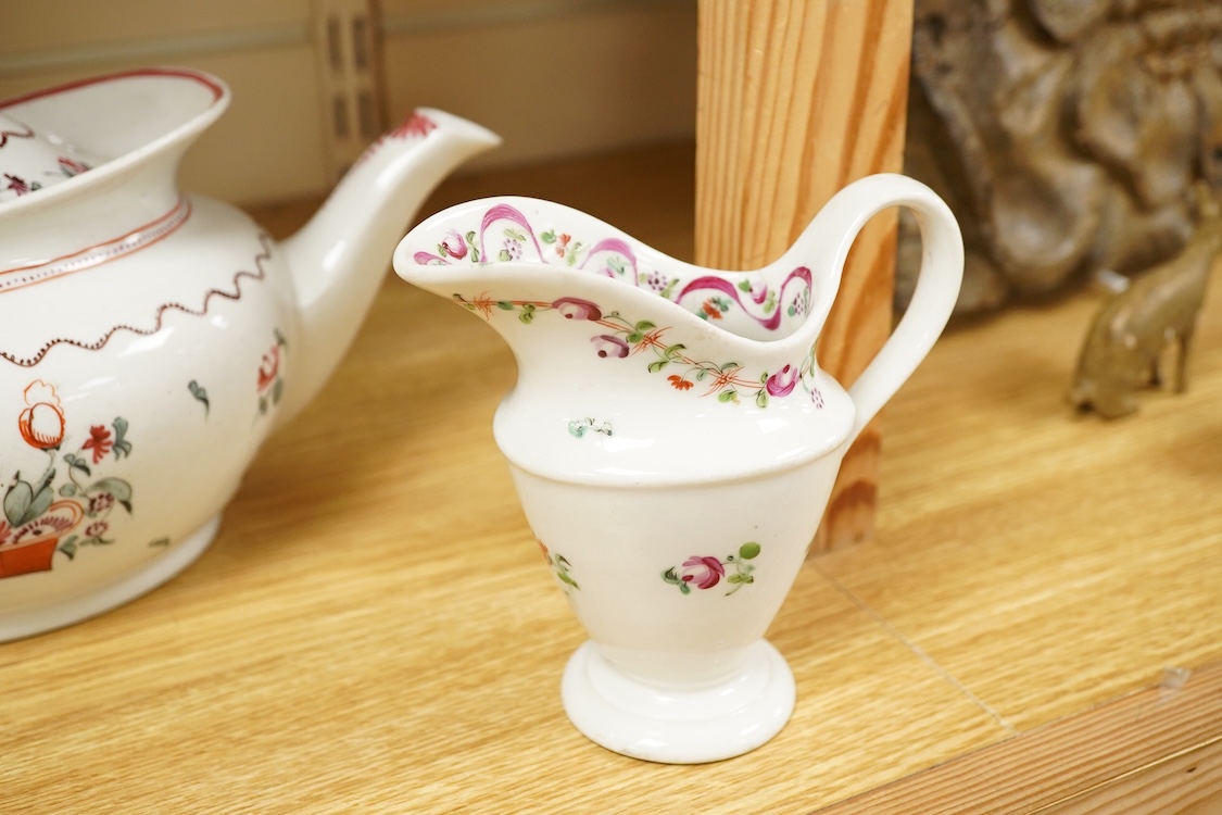 A Newhall porcelain boat shaped teapot, c.1800, together with a cream jug, tallest 14cm